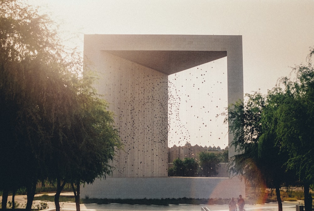 green trees near white concrete building during daytime