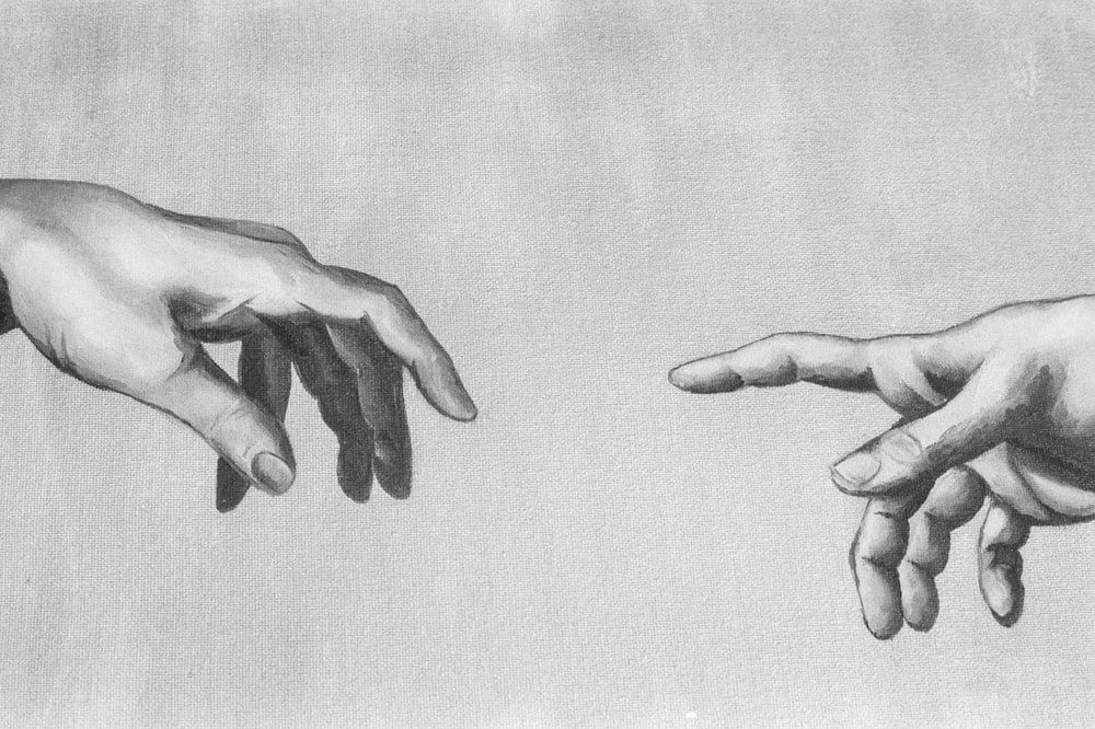 grayscale photo of 2 hands