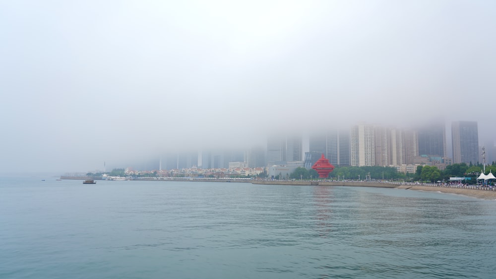 body of water near city buildings during daytime