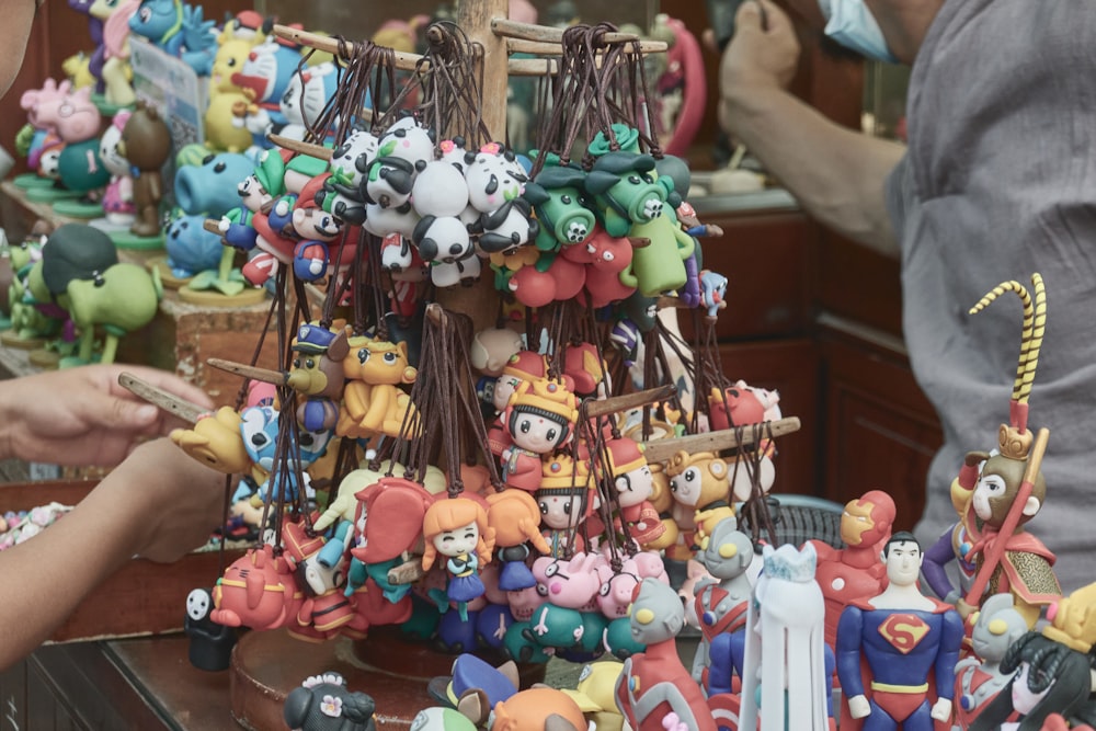 assorted plastic toys on brown wooden rack