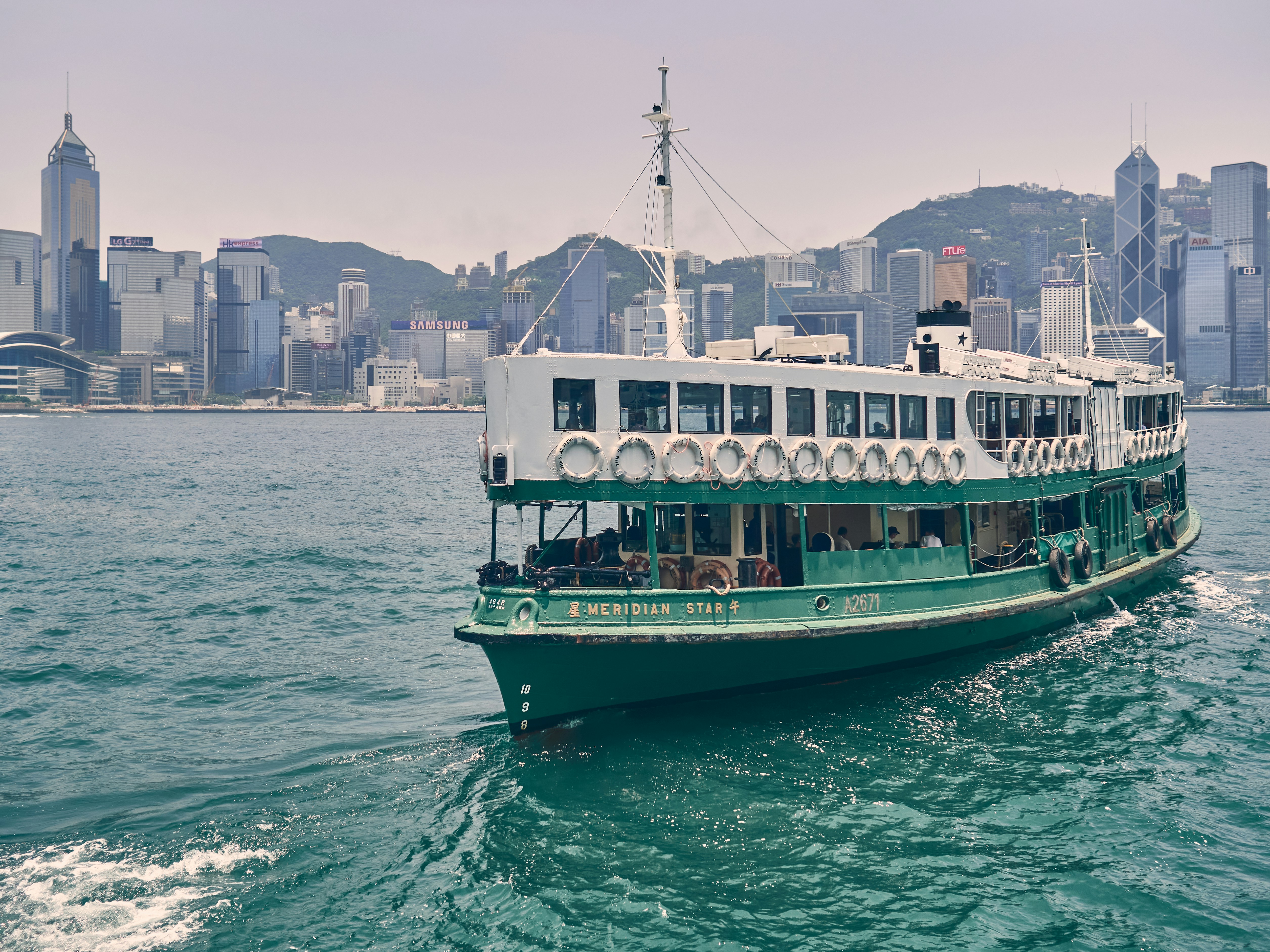 green and white boat on sea during daytime