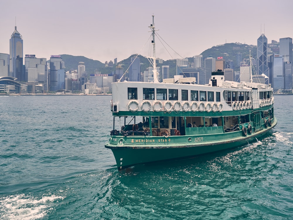 green and white boat on sea during daytime