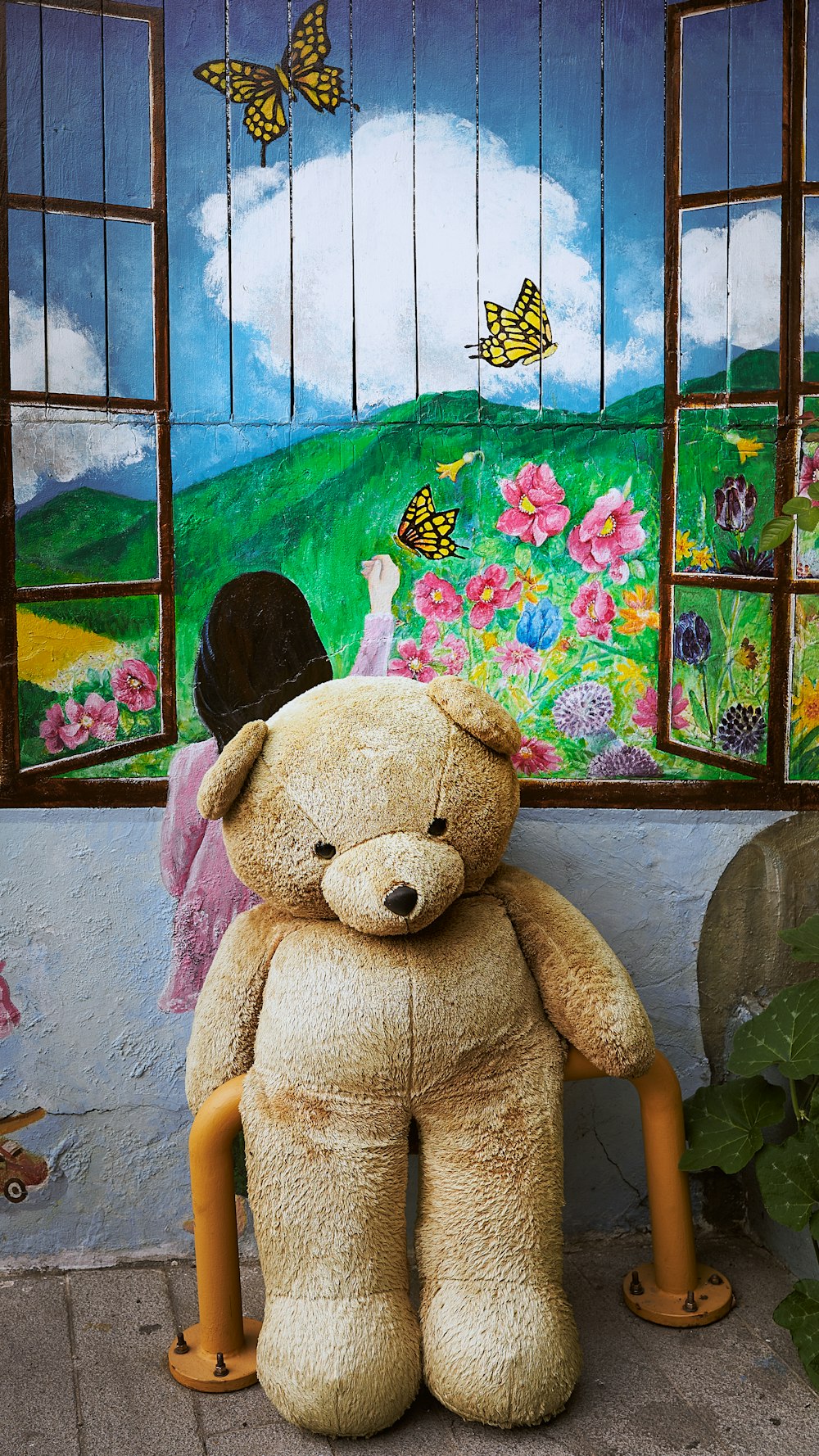 brown bear plush toy on graffiti wall