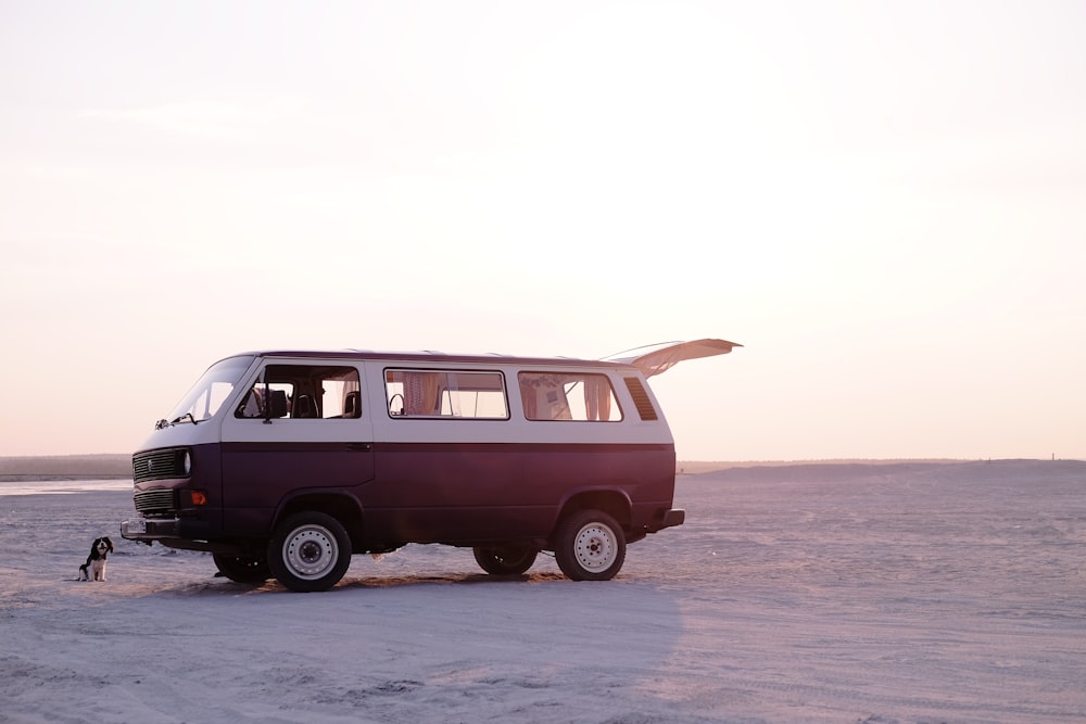 red van on gray sand during daytime