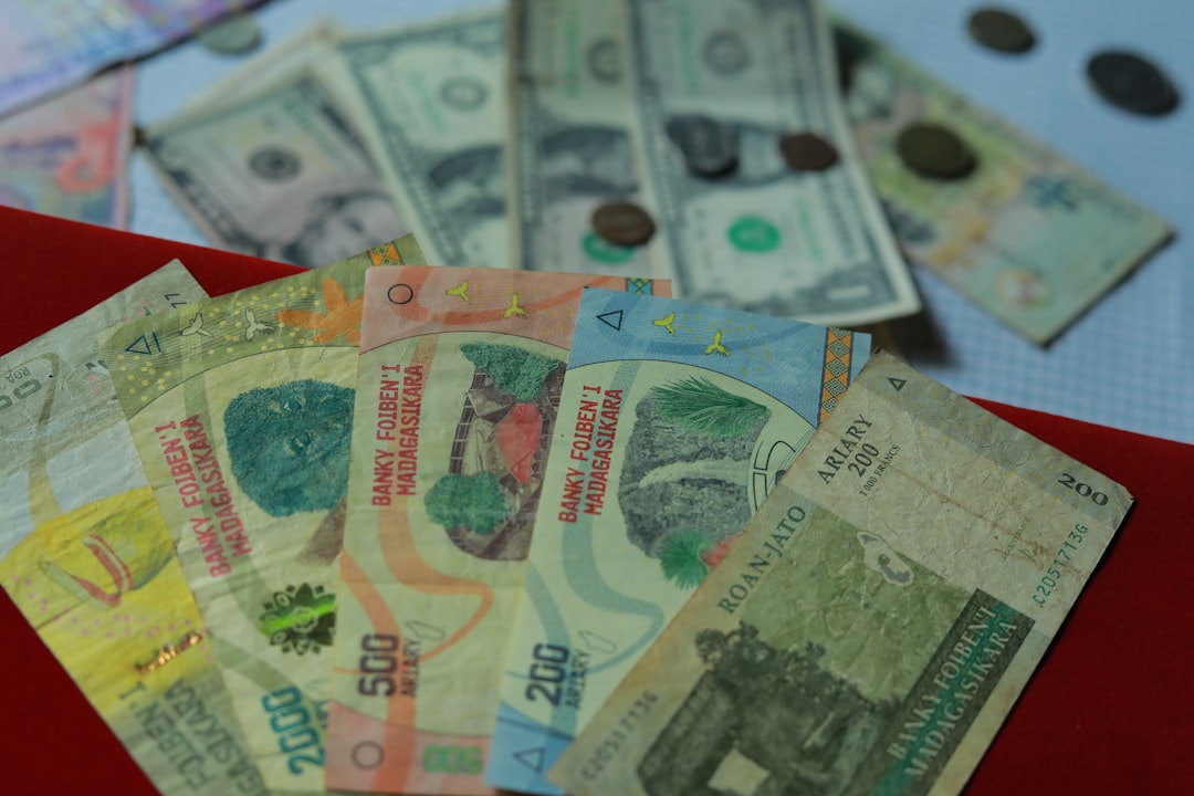 10 and 20 banknotes on red textile,