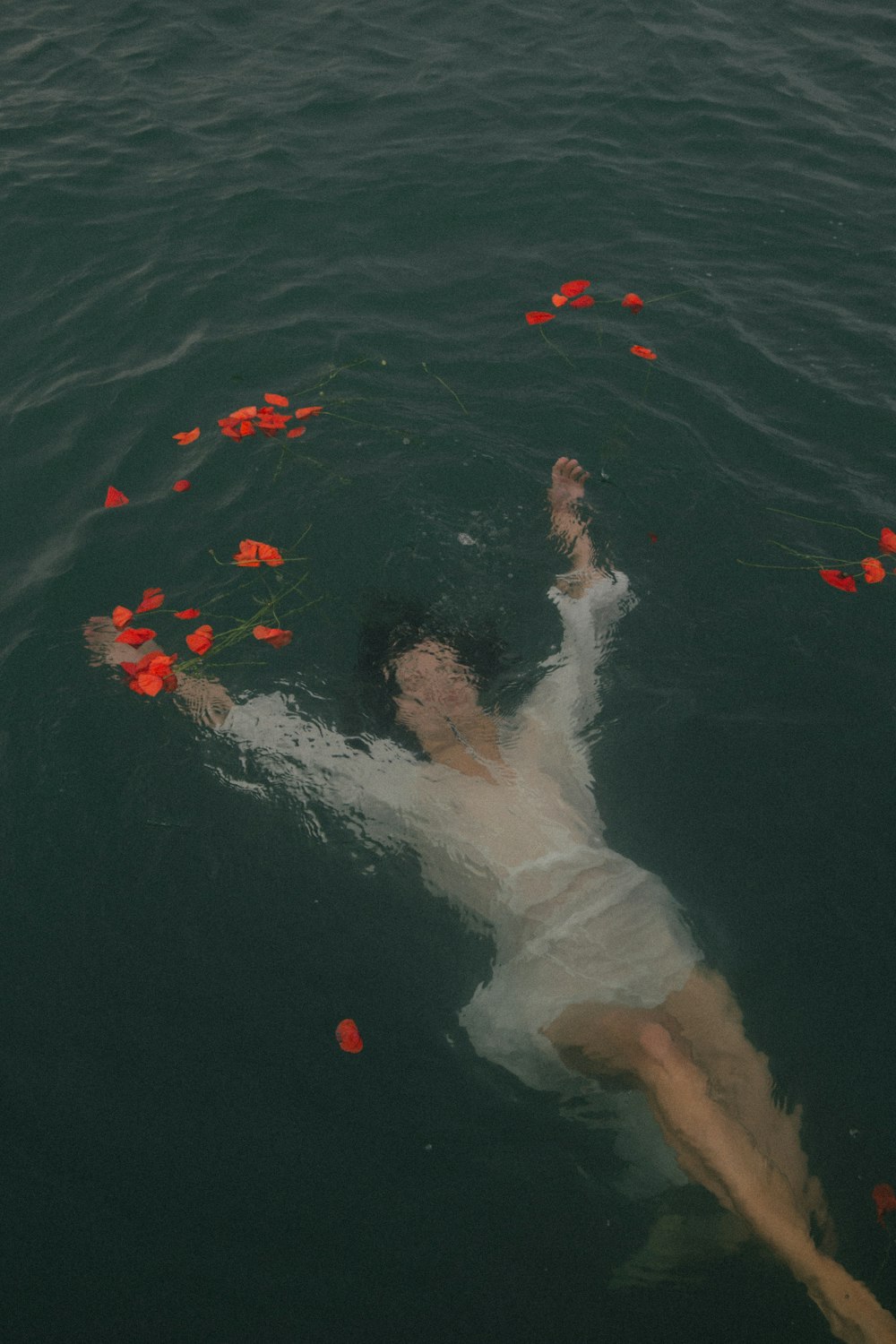 person in blue shorts swimming on water