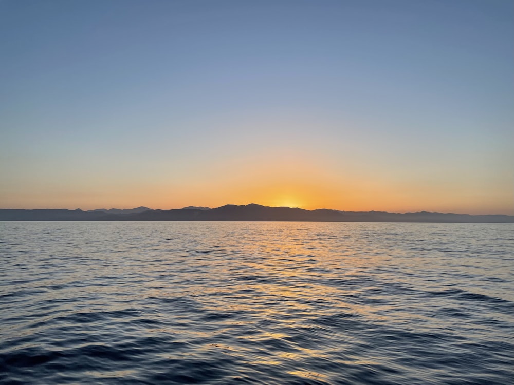 body of water during sunset