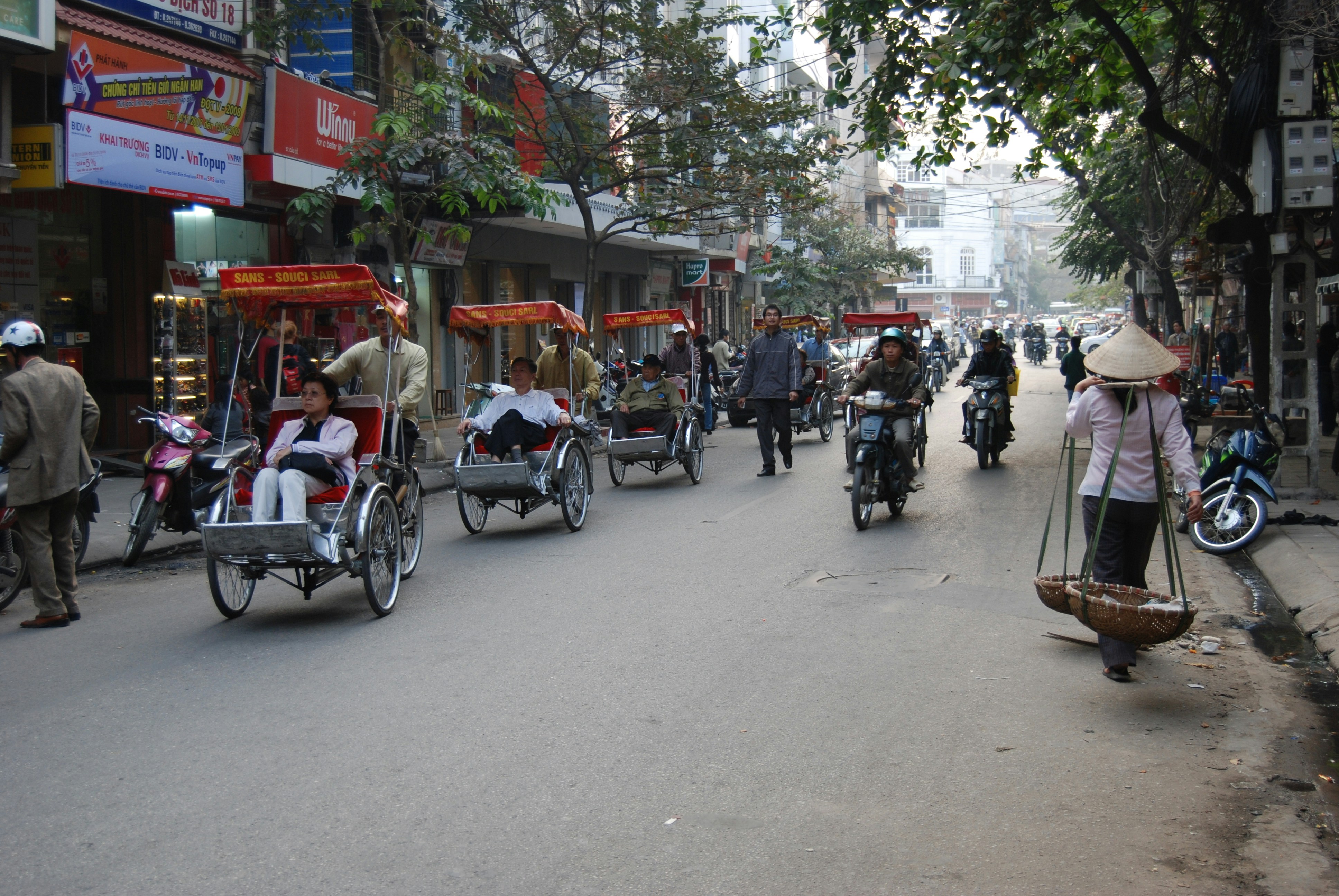 people riding on a red and white food cart during daytime