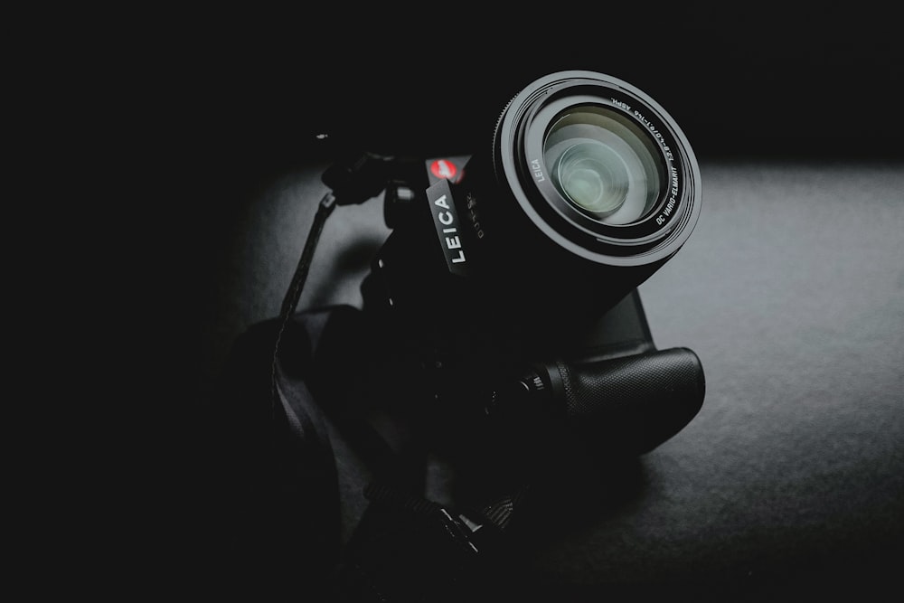 black dslr camera on black surface