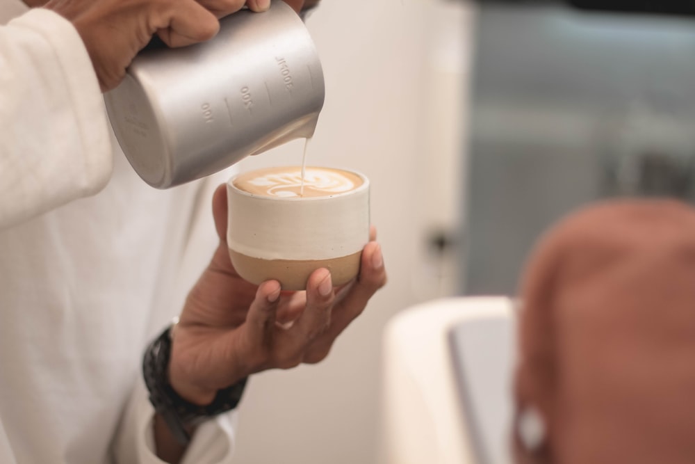 person holding white plastic cup