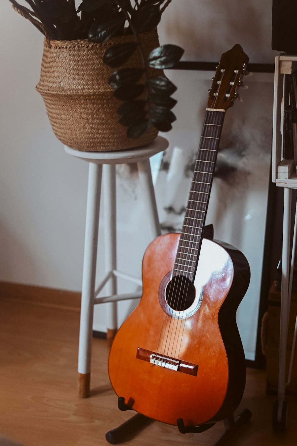 brown acoustic guitar on brown wooden seat