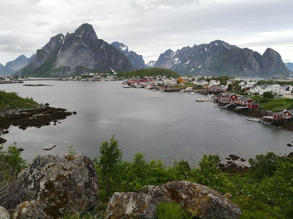 body of water near mountain during daytime