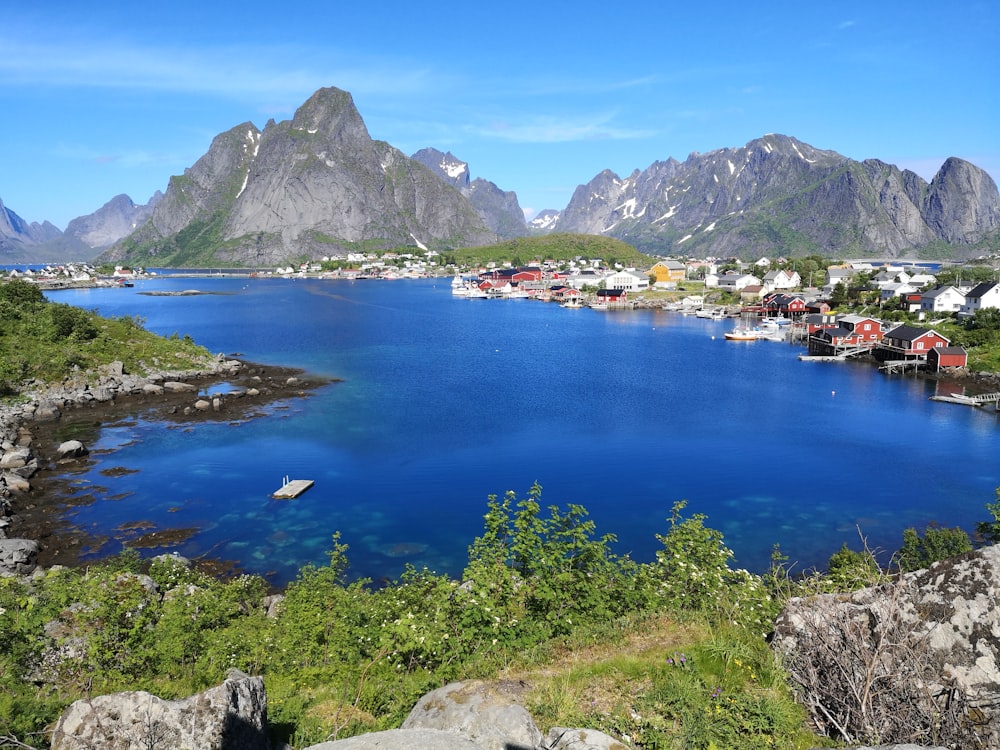 body of water near mountain during daytime