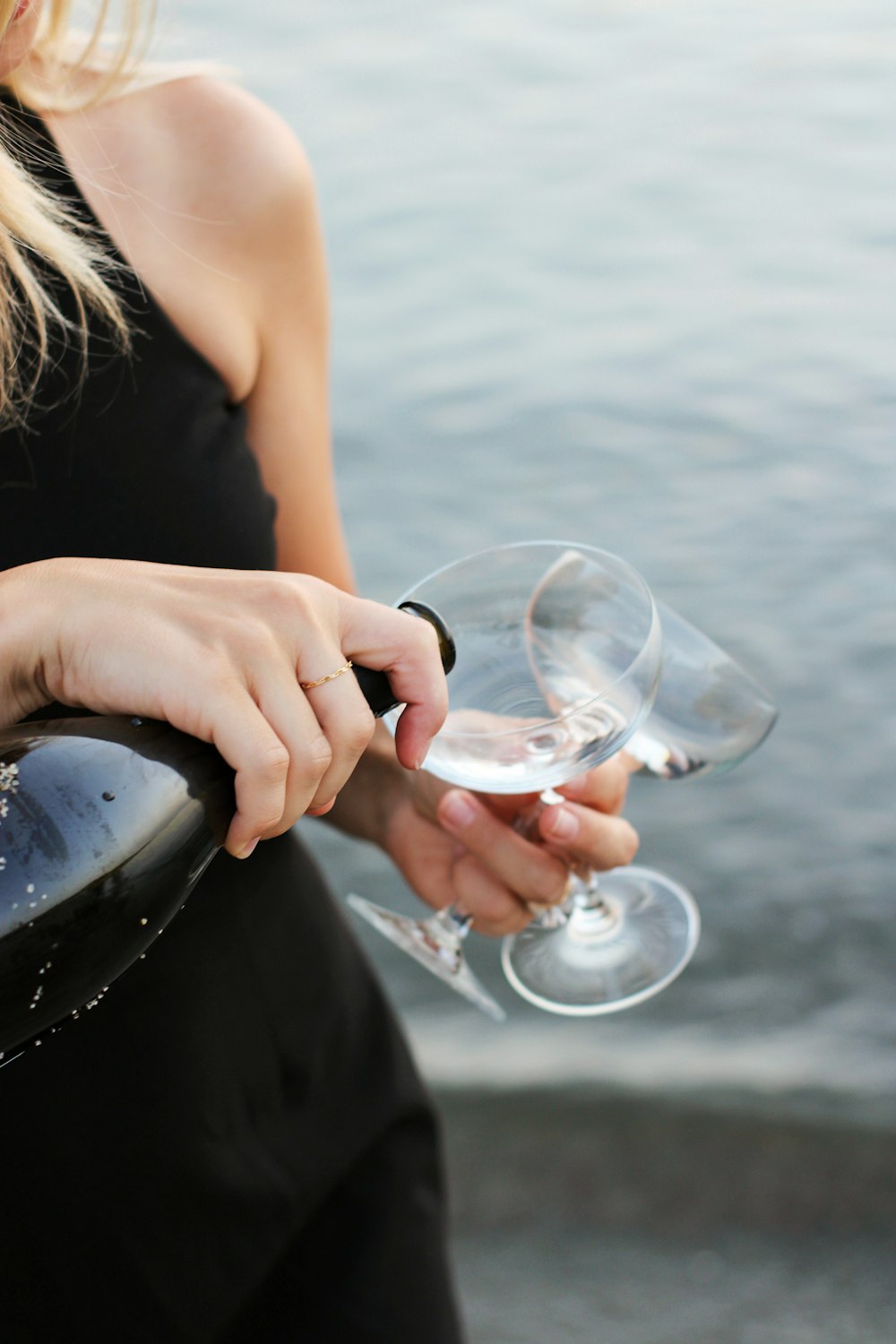 woman in black tank top holding wine glass