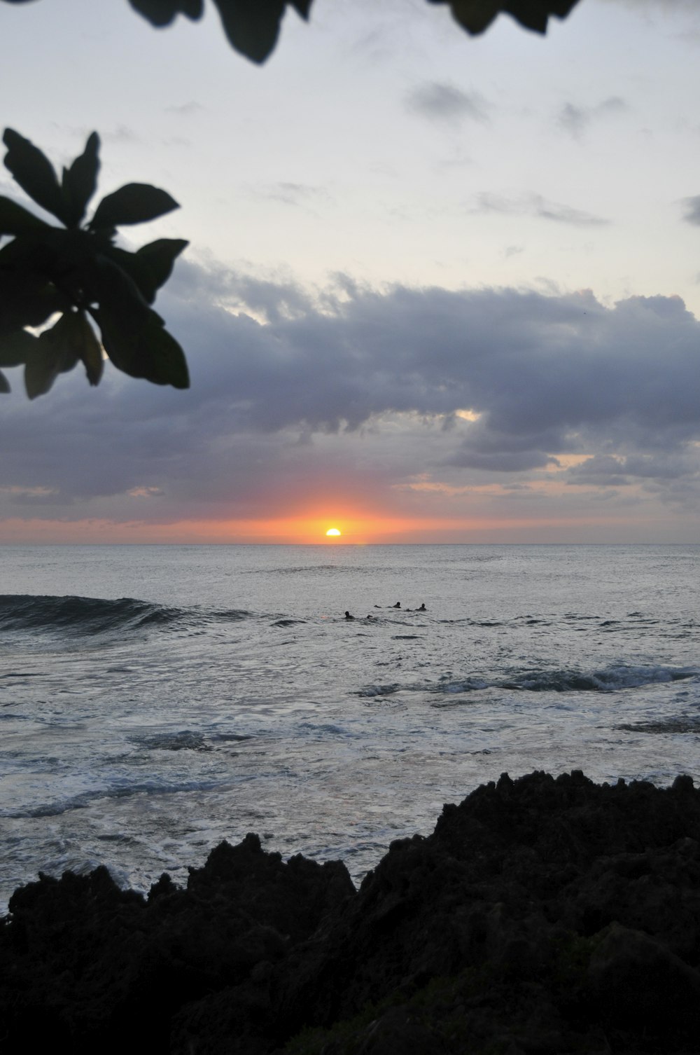 ocean waves crashing on rocks during sunset