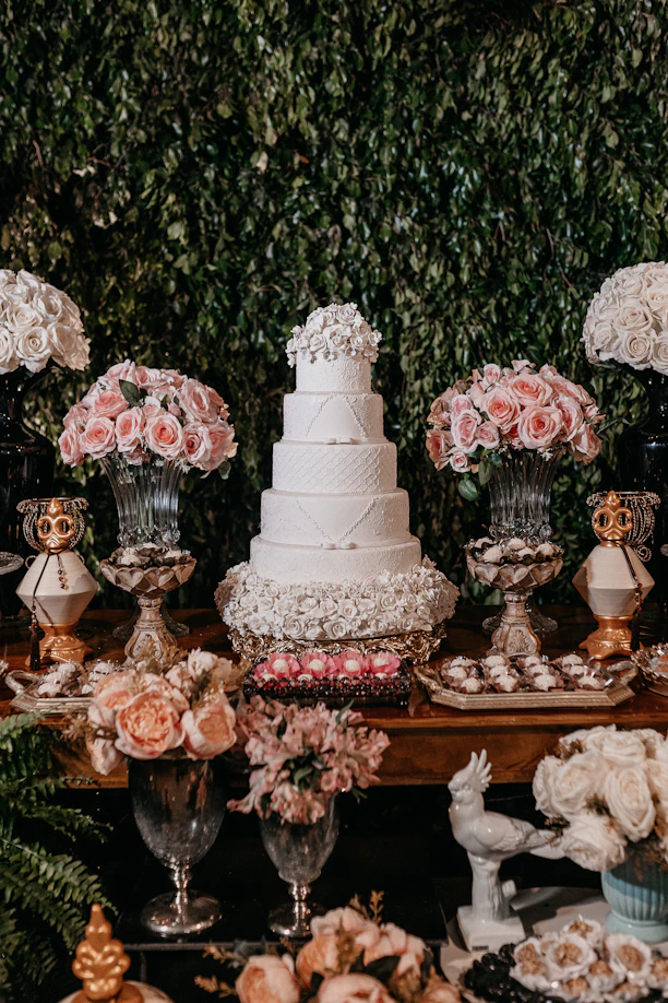 white and pink floral cake on brown wooden table