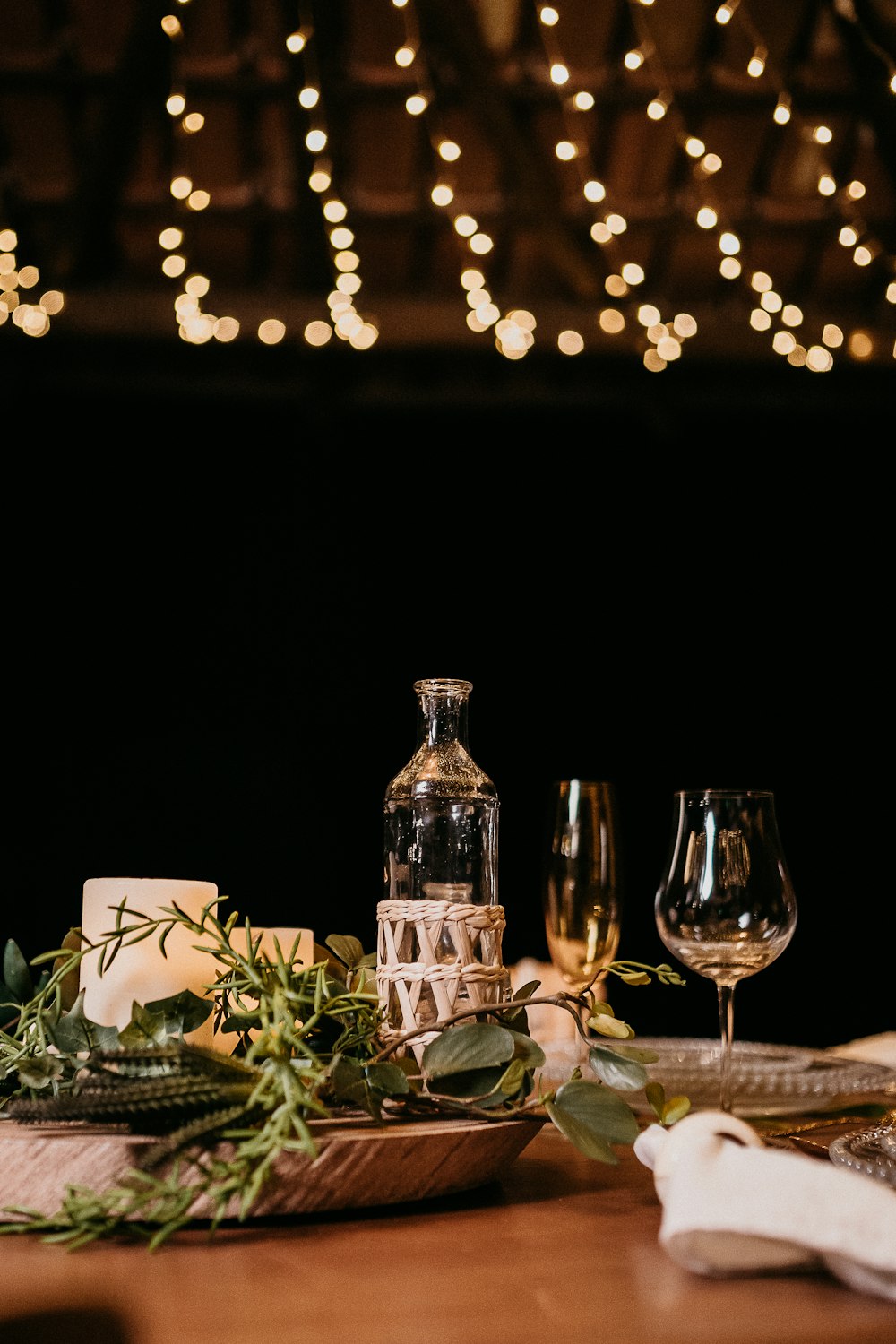 clear glass bottle beside white ceramic mug