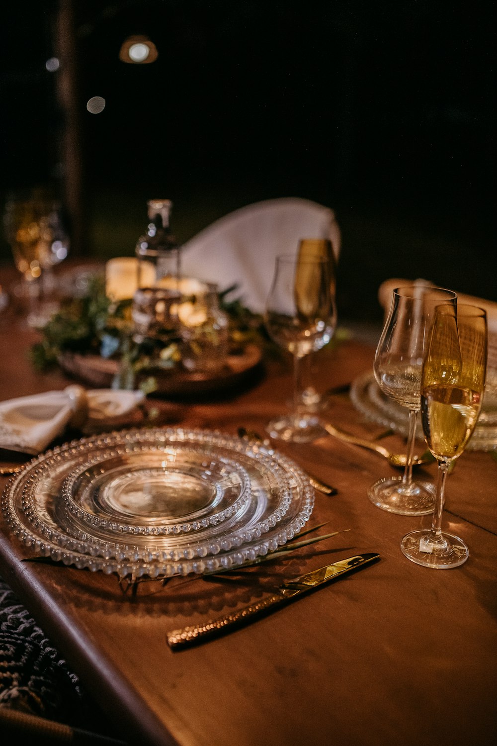 clear wine glass on silver round tray