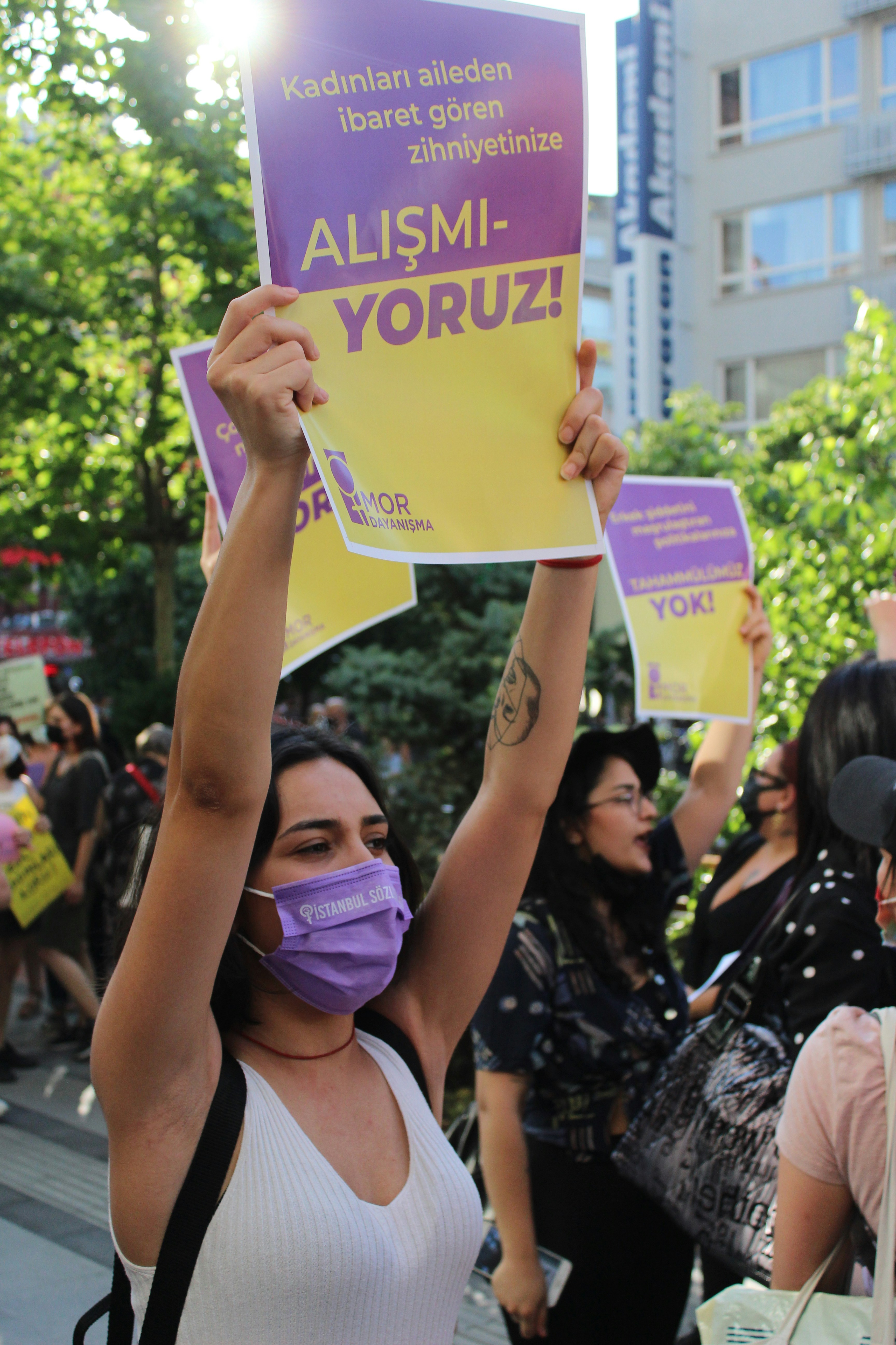 woman in black and white floral dress holding yellow paper