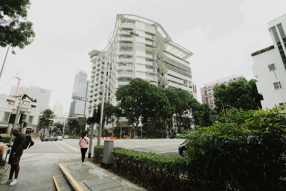 green trees near white concrete building during daytime