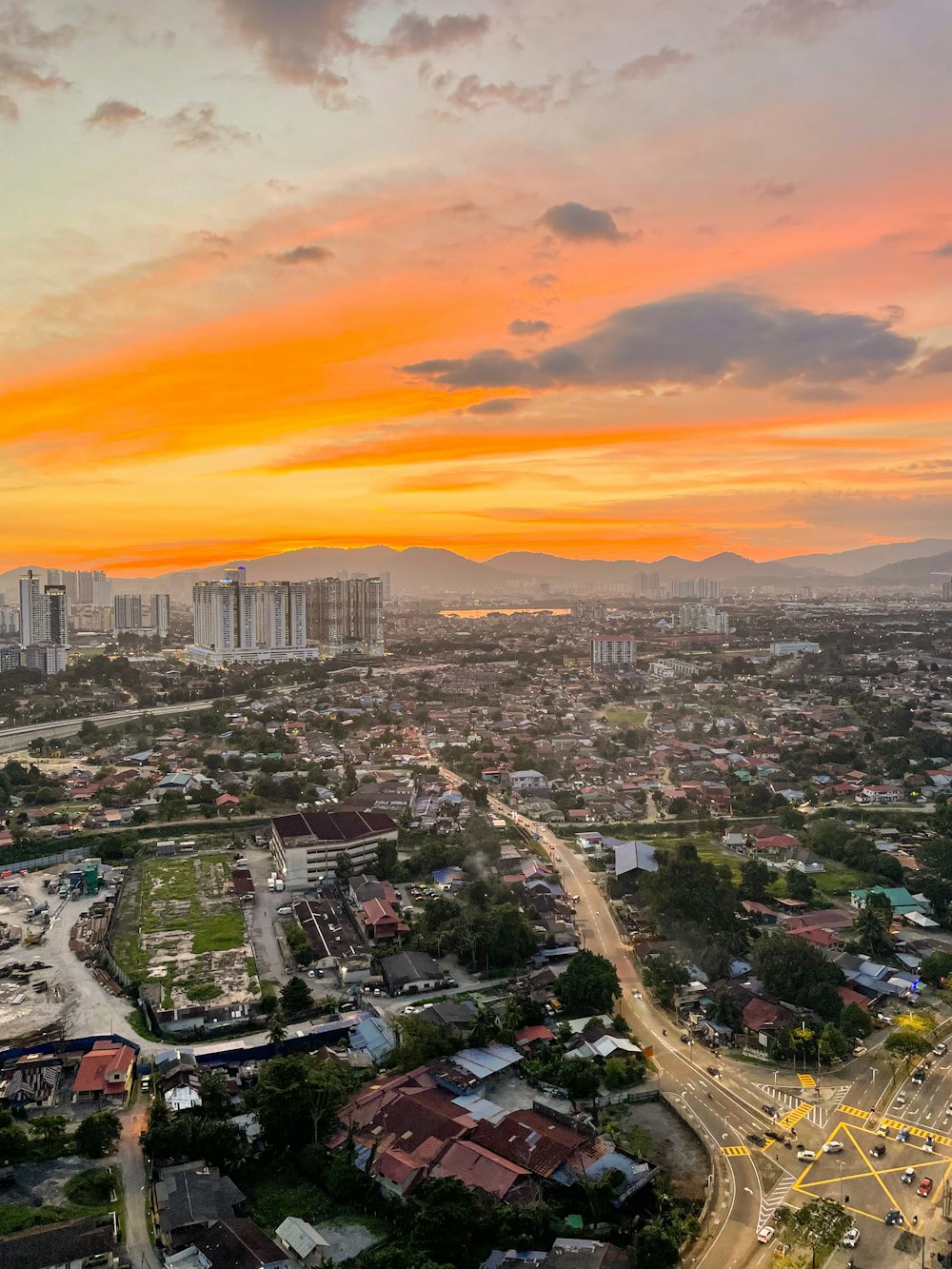 city skyline under orange sky during sunset