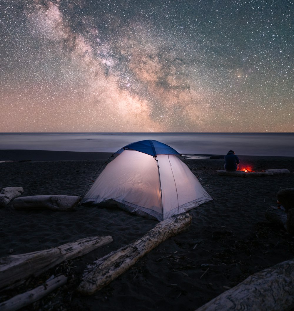 white tent on brown sand during night time