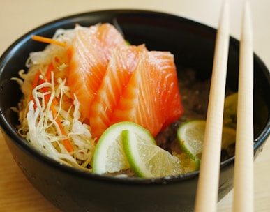 white chopsticks on black ceramic bowl