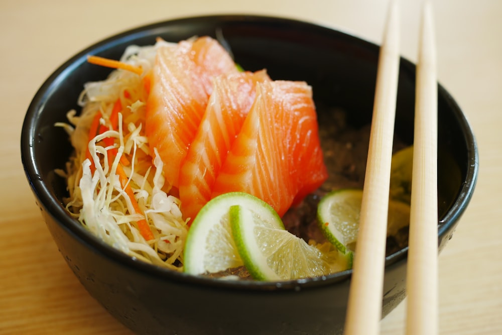 white chopsticks on black ceramic bowl