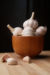 garlic on brown wooden bowl