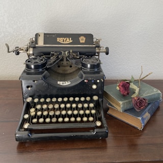 black and white typewriter on brown wooden table