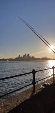 A scenic view of anglers fishing on the calm waters of Rio Parada during sunset.