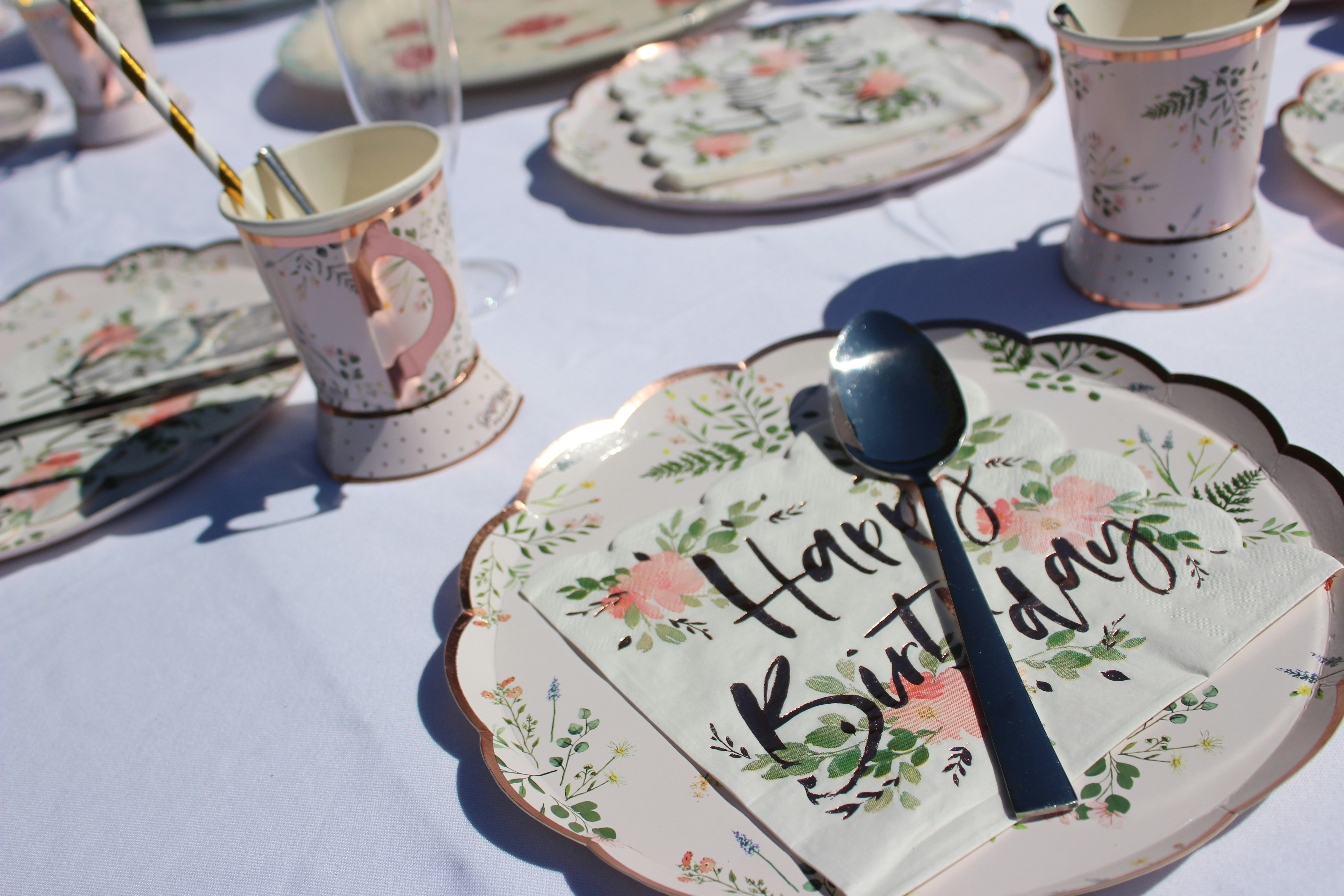 stainless steel spoon on white and green floral ceramic plate
