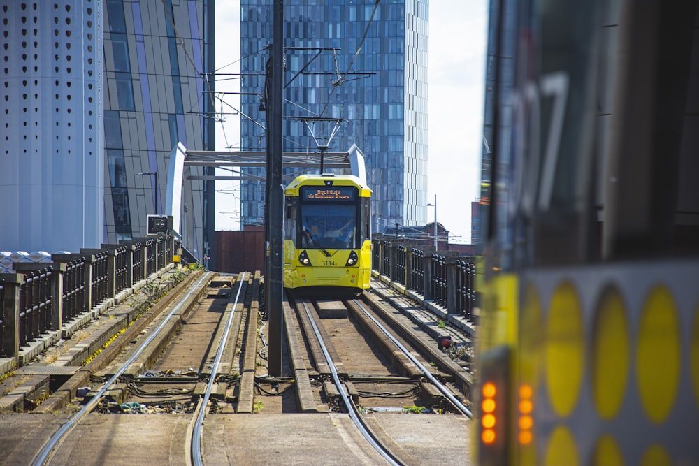 yellow and white train on rail tracks