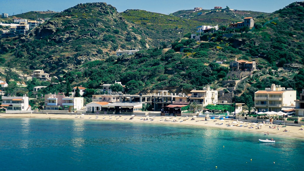 green mountain beside body of water during daytime