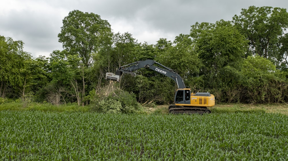 yellow and black heavy equipment on green grass field during daytime