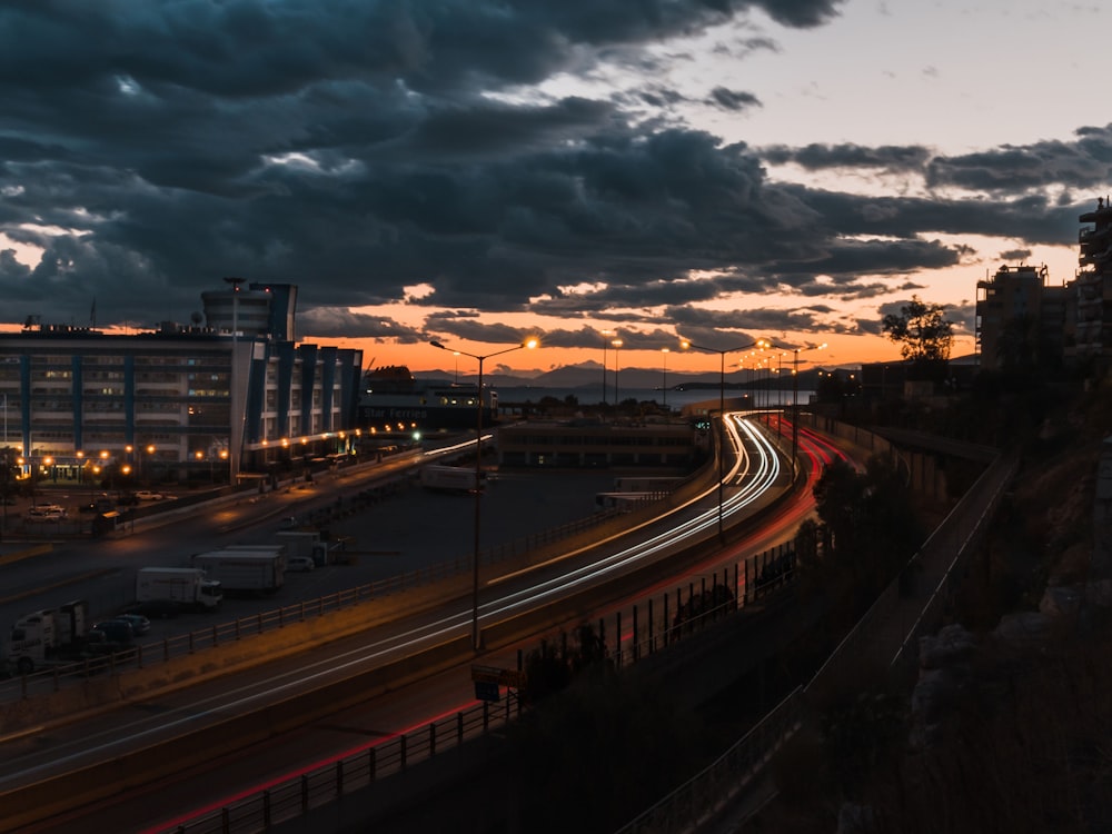 city buildings under gray clouds during sunset