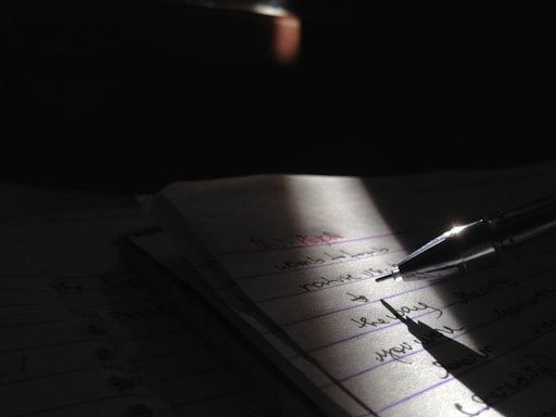 Close-up of a pen resting on a conveyancing contract with a gentle blue light emphasizing serious attention to detail.