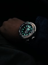 person wearing black and silver chronograph watch