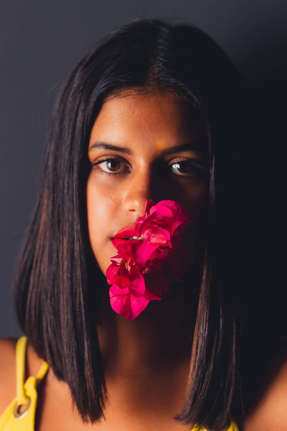 woman with red rose on her ear