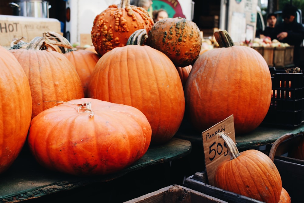 orange pumpkins on black wooden table