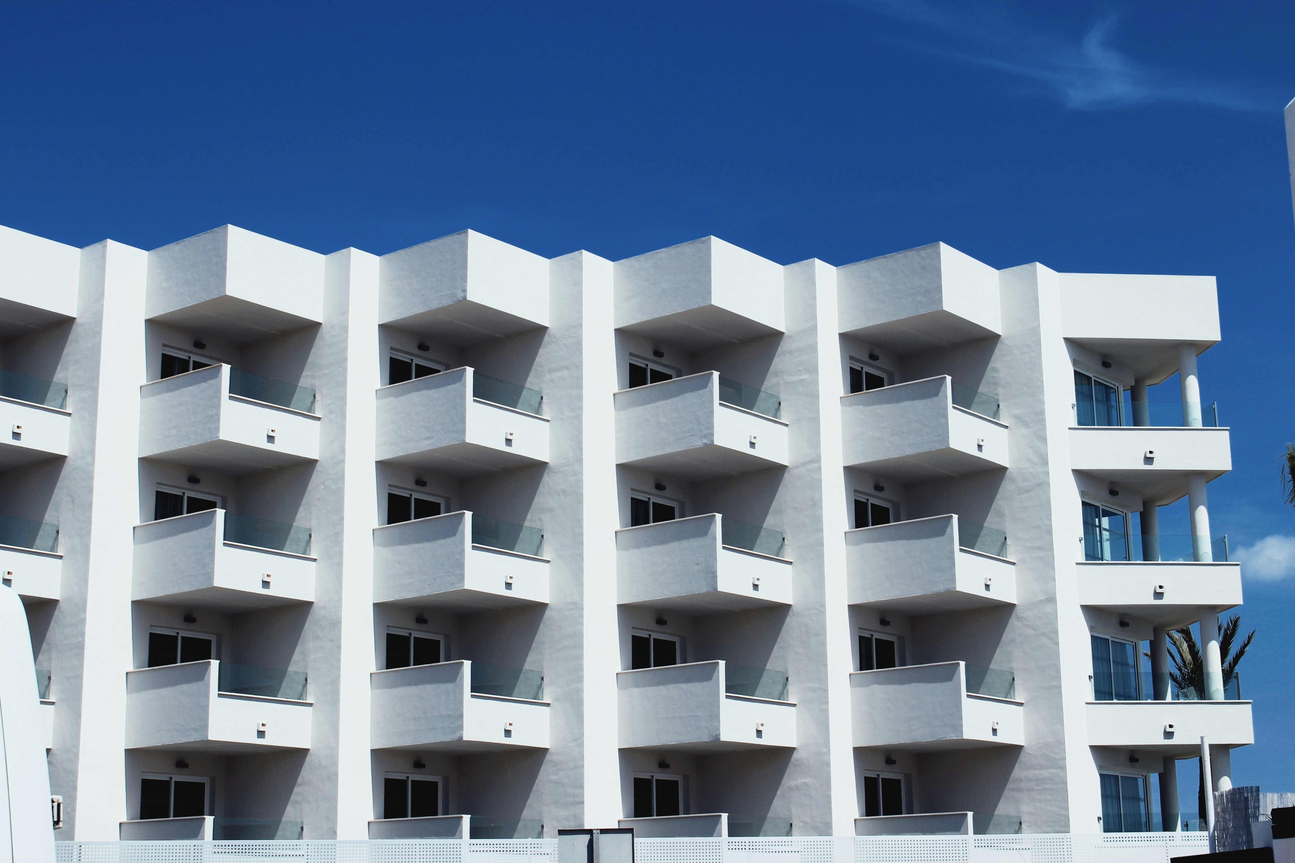 white concrete building under blue sky during daytime, 
