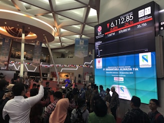 people in a building with lights stock markets