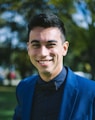 man in blue suit jacket smiling