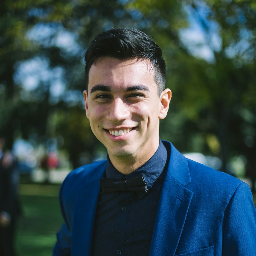 man in blue suit jacket smiling