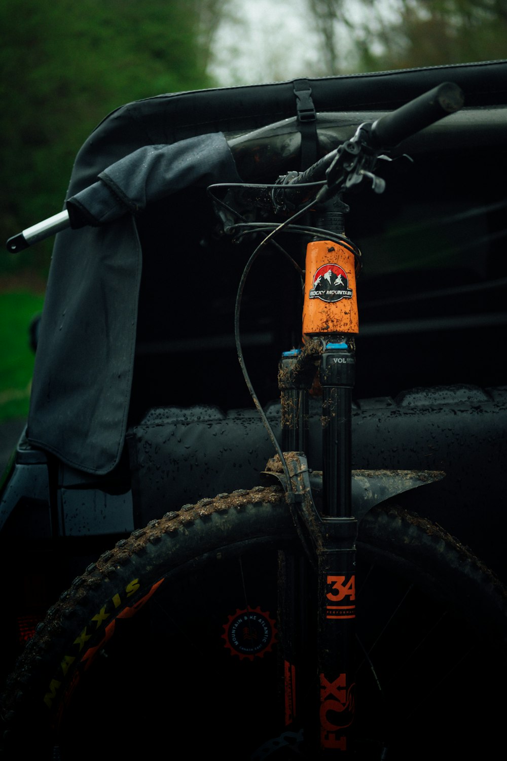 person in black jacket and black pants riding black bicycle