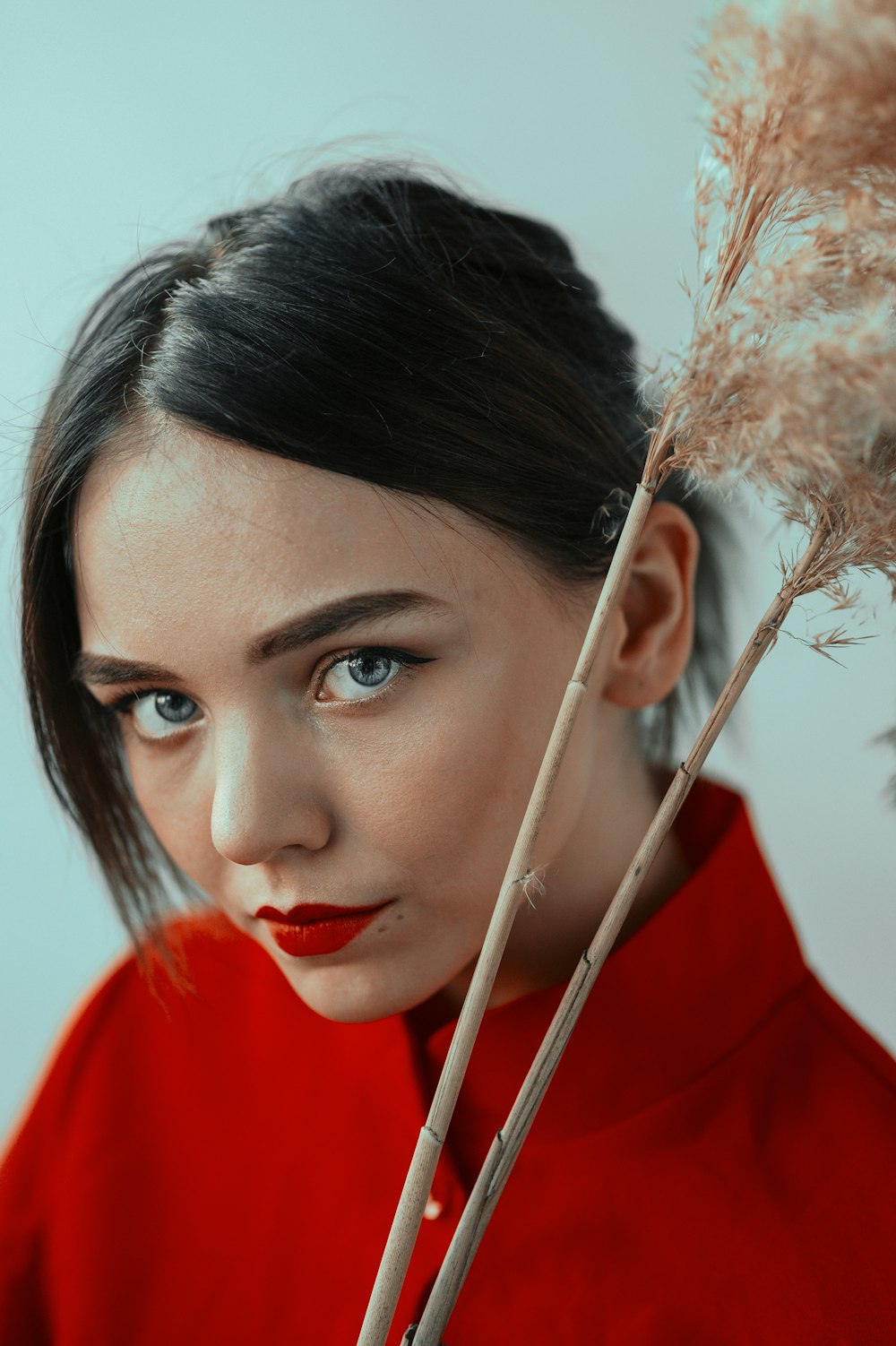 woman in red shirt with white earbuds