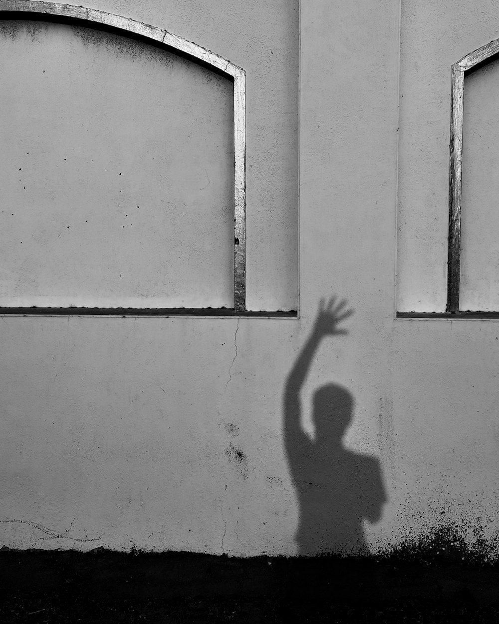 person standing on white concrete wall