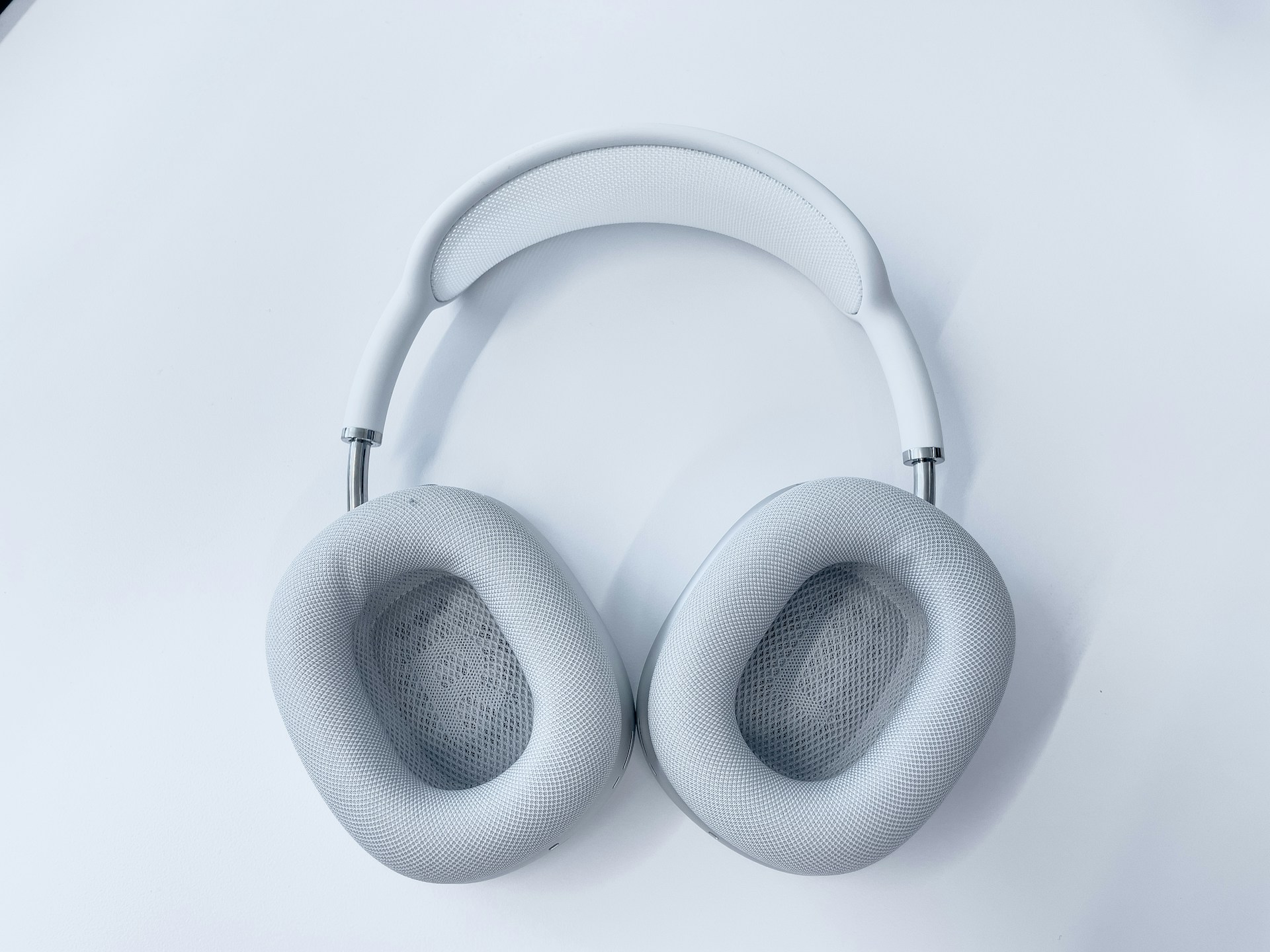 white wireless headphones on white surface