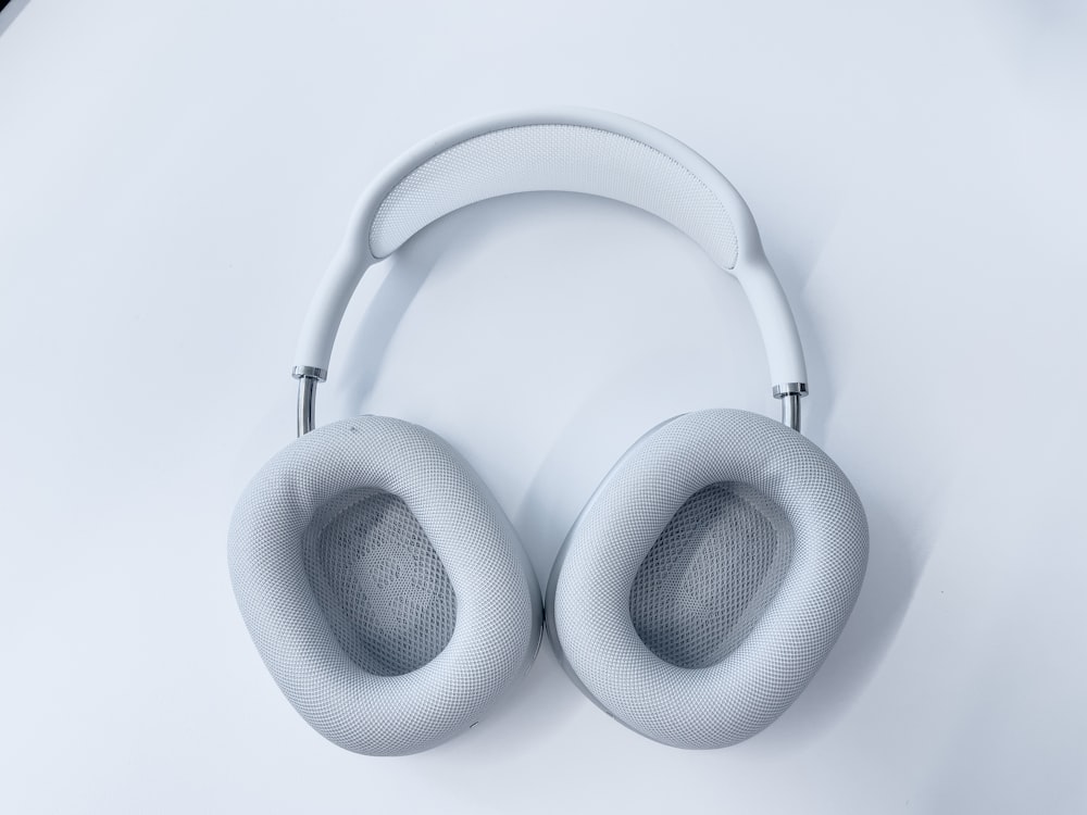 white wireless headphones on white surface