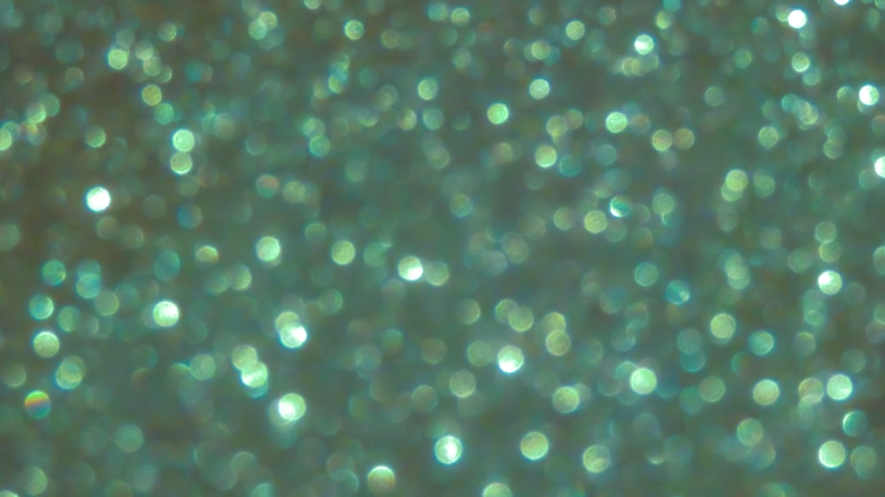 Green glitter surface with green light bokeh it can be used for background